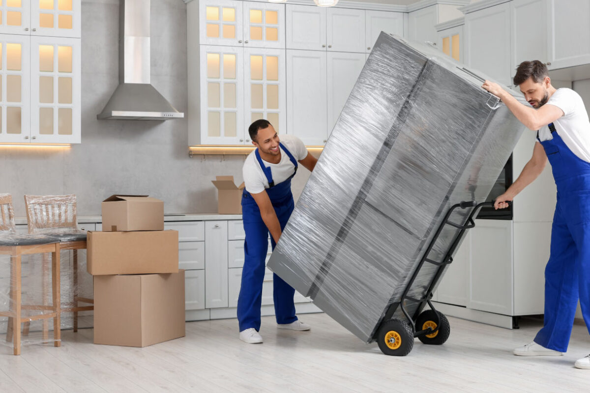Residential movers packing a fridge